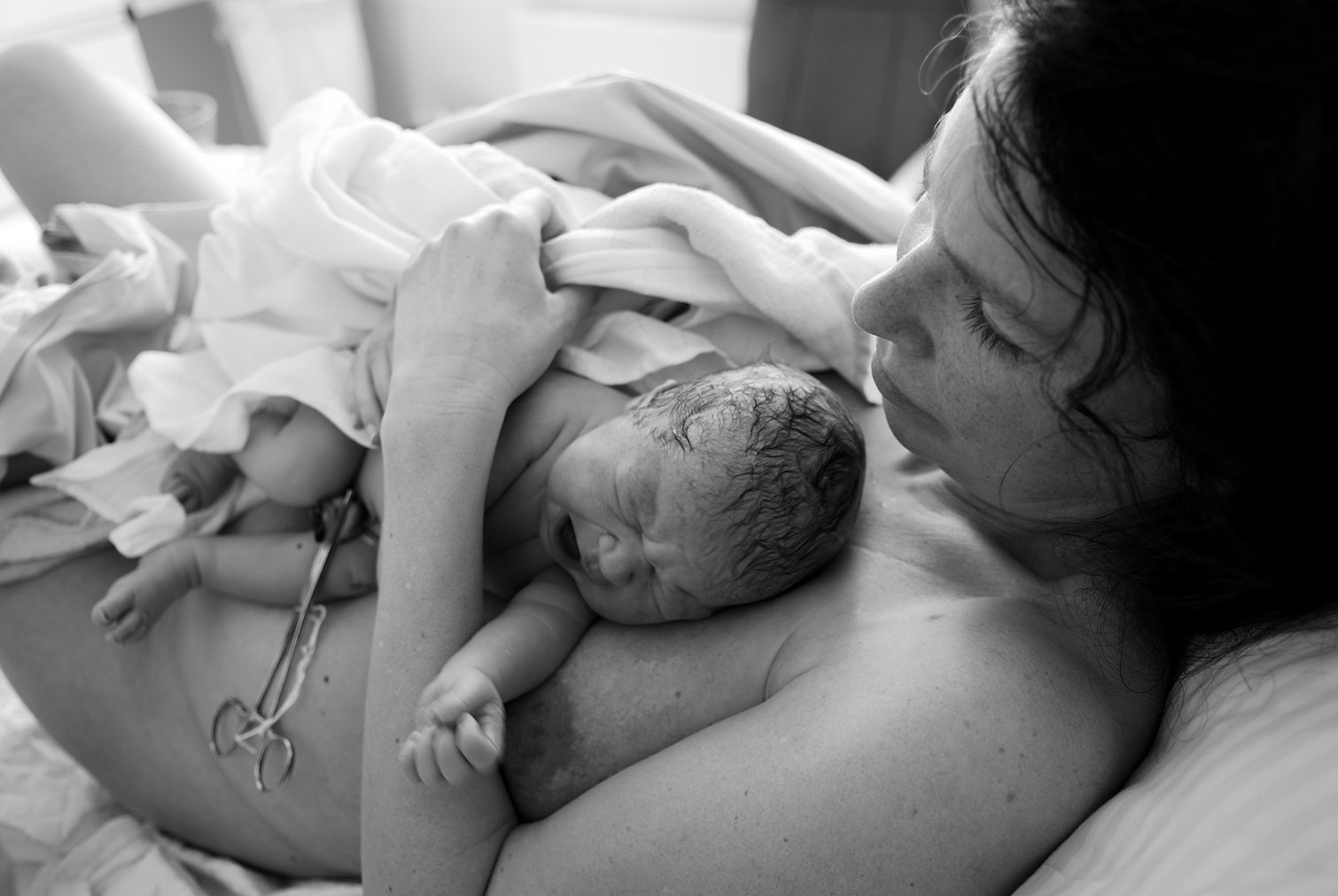 Newborn Baby Lying on Mothers Chest After Birth